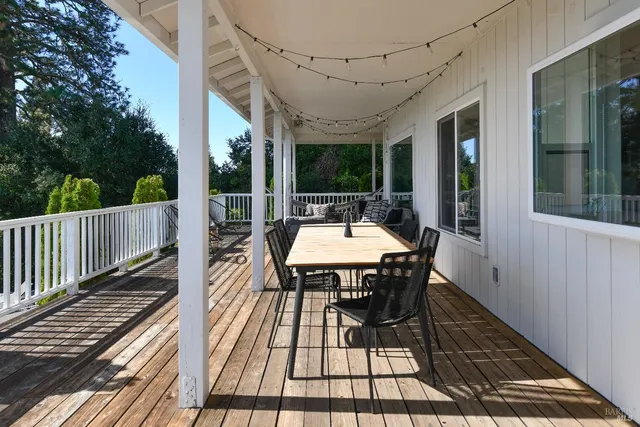 a view of balcony with furniture and umbrella