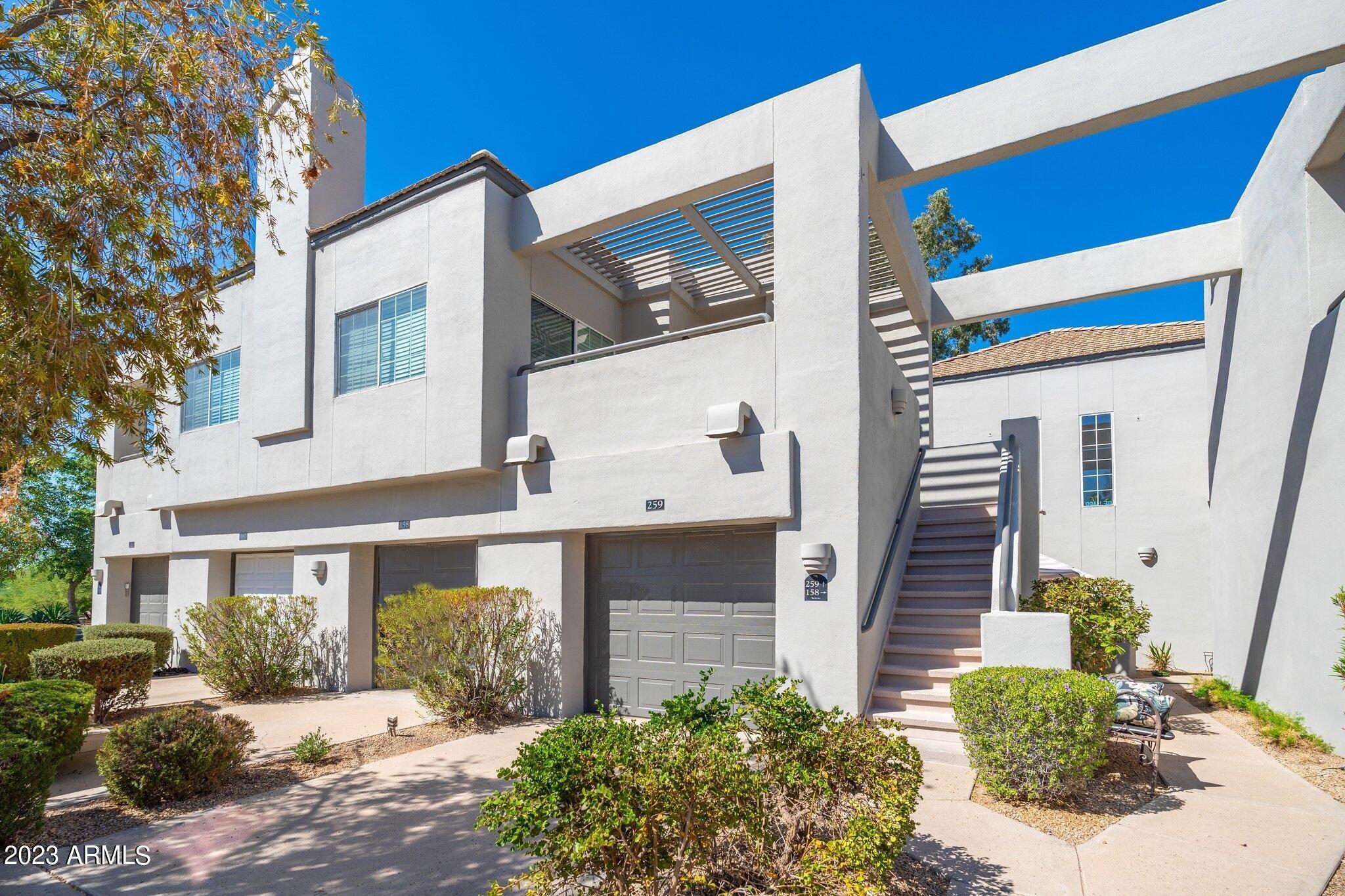 7710 East Gainey Ranch Road, Unit 259 Scottsdale, AZ 85258 - Photo 1 of 48 a front view of a house with a yard