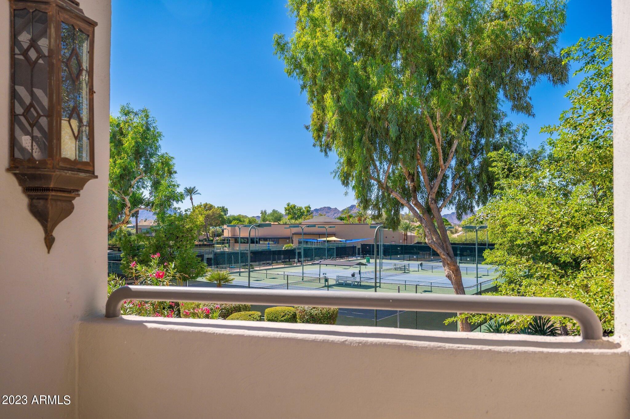 7710 East Gainey Ranch Road, Unit 259 Scottsdale, AZ 85258 - Photo 27 of 48 a view of a yard with a bench and trees
