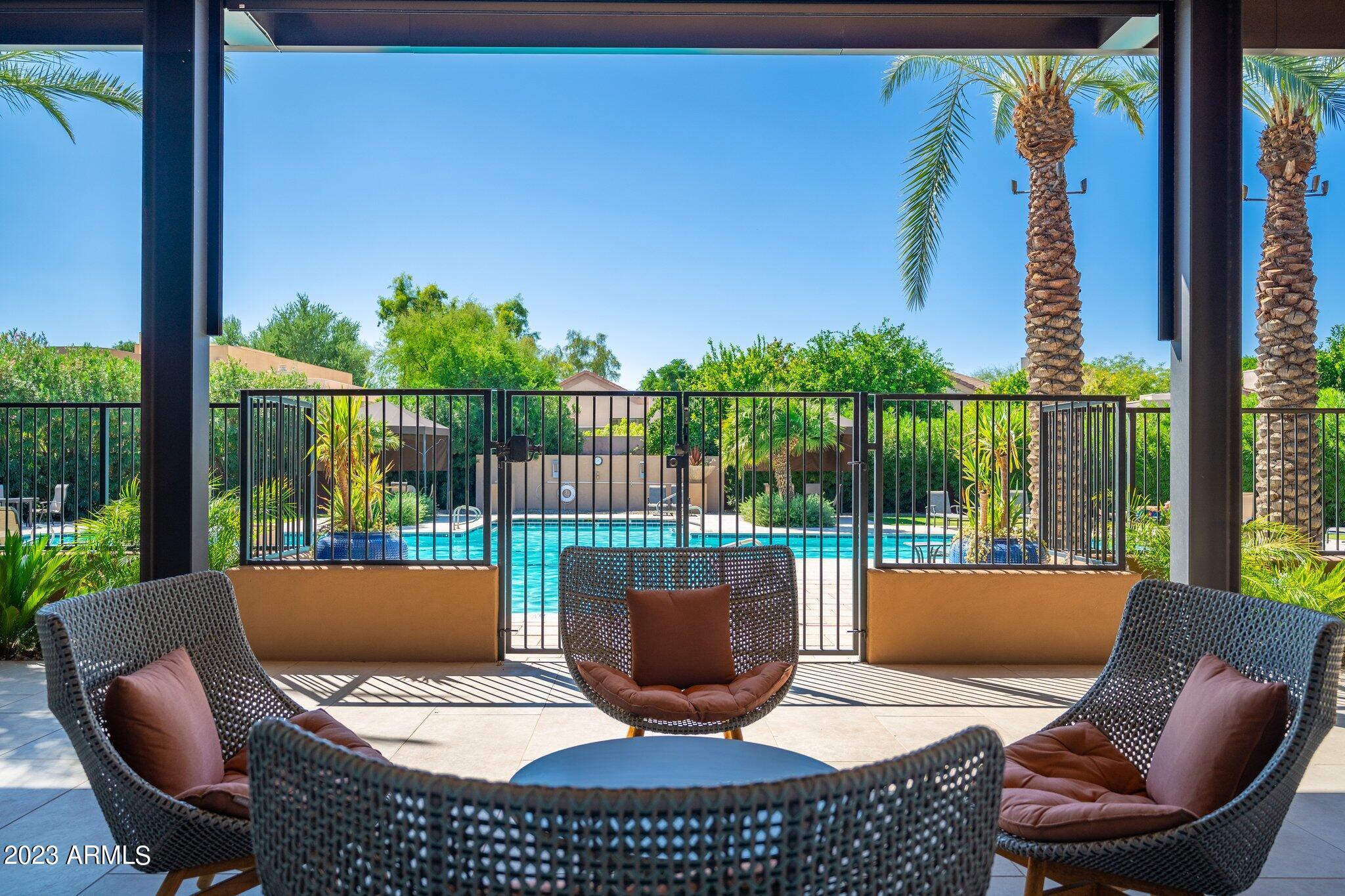 7710 East Gainey Ranch Road, Unit 259 Scottsdale, AZ 85258 - Photo 29 of 48 a view of a balcony with chair and a potted plant