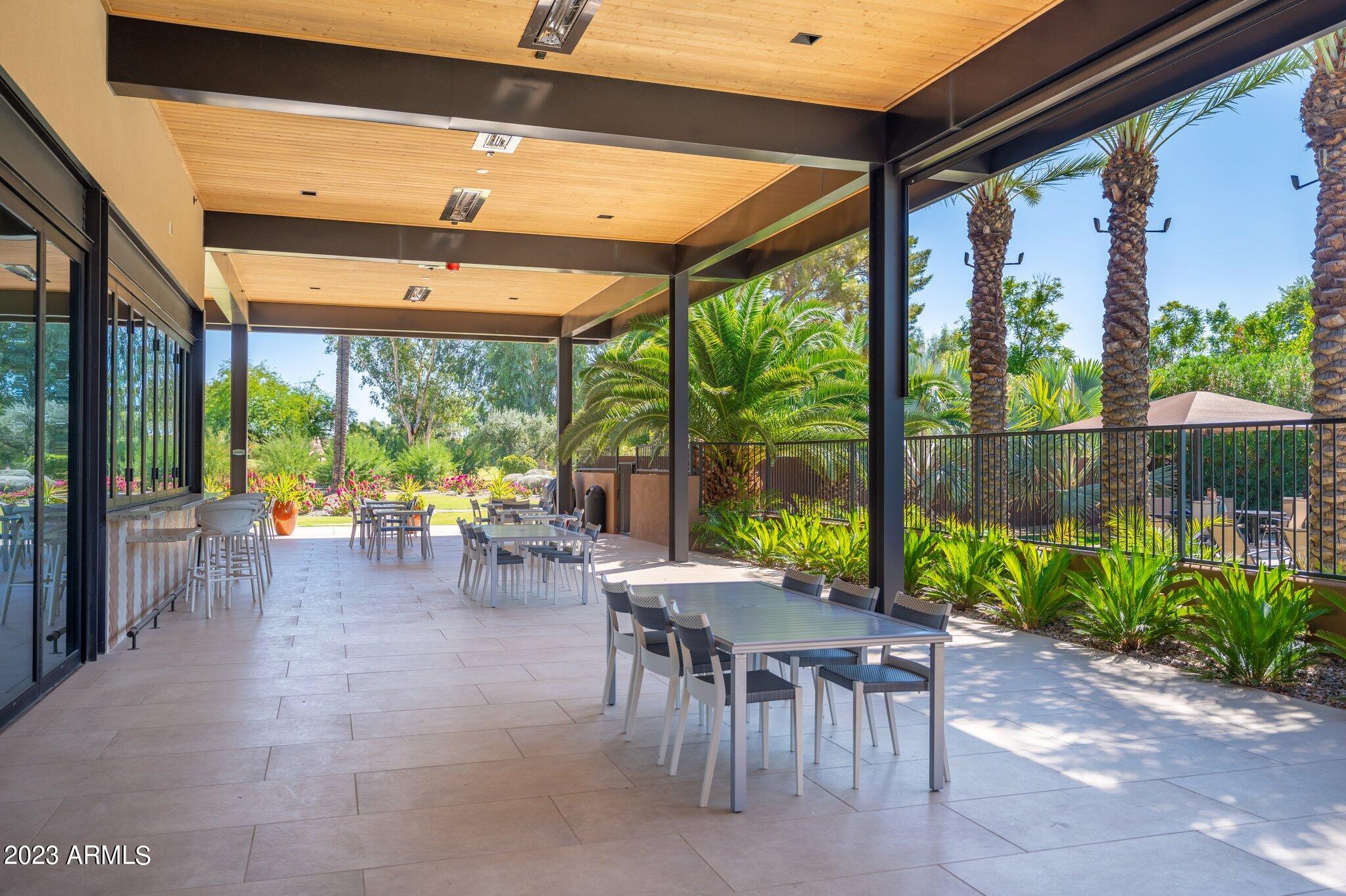 7710 East Gainey Ranch Road, Unit 259 Scottsdale, AZ 85258 - Photo 31 of 48 a view of a patio with table and chairs and potted plants