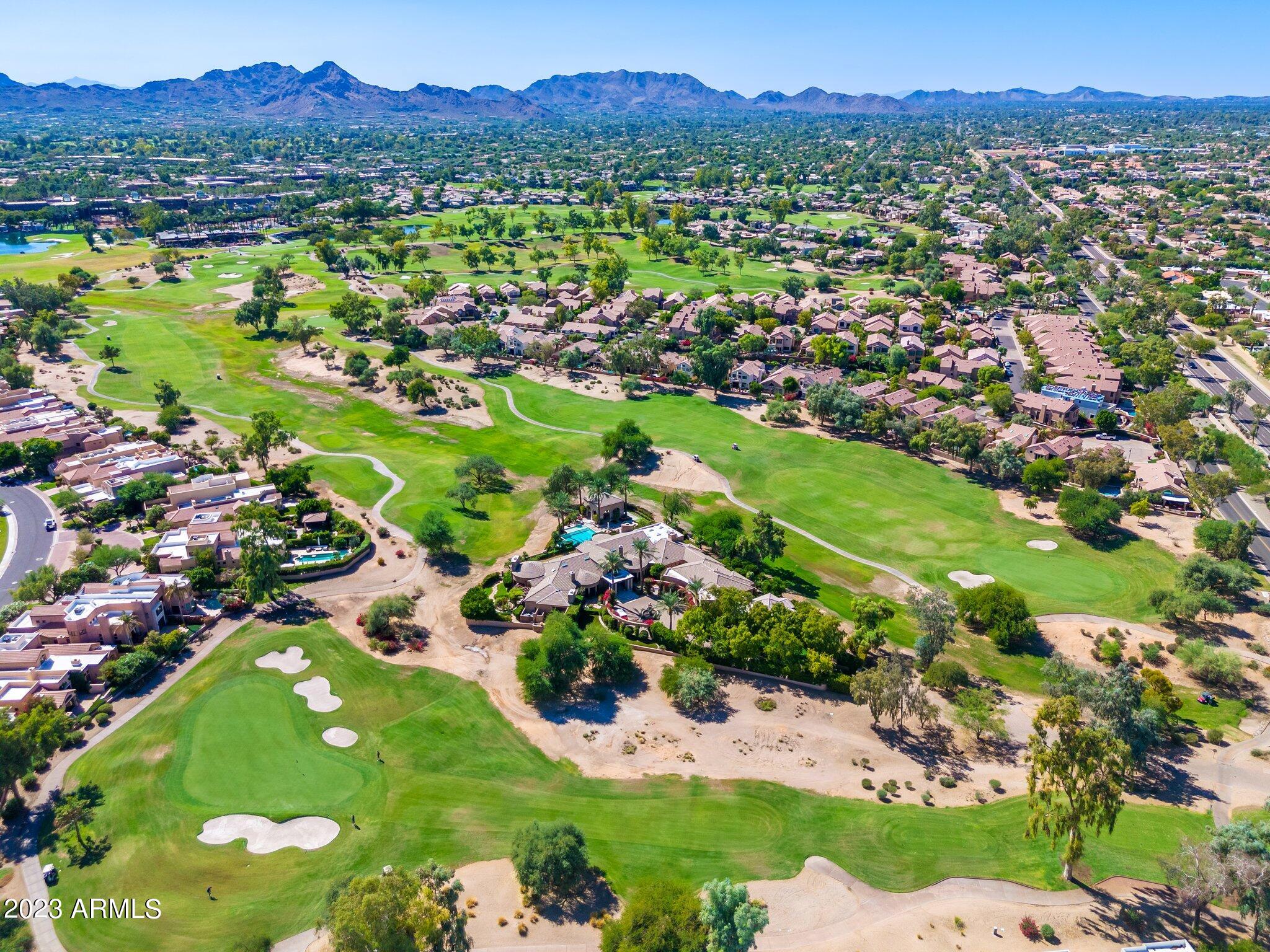 7710 East Gainey Ranch Road, Unit 259 Scottsdale, AZ 85258 - Photo 42 of 48 a view of a lake with a mountain