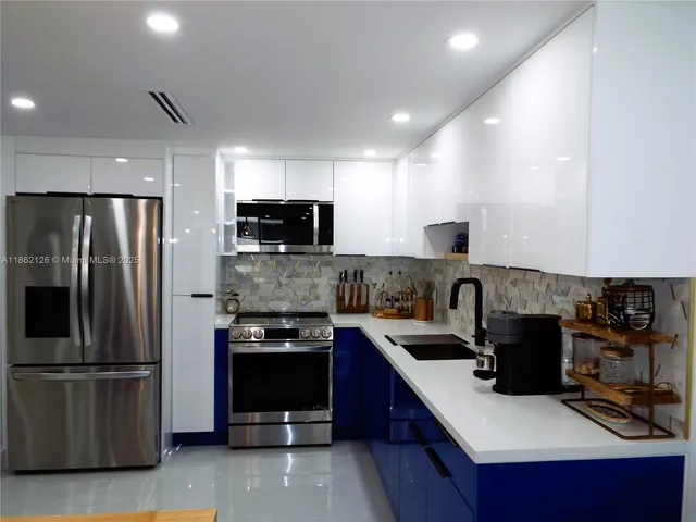 a bedroom with a bed a dresser and next to a window