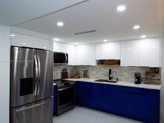 a large bed in a bedroom next to a window