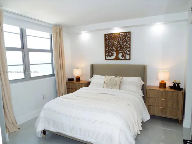 a bedroom with a bed and a potted plant