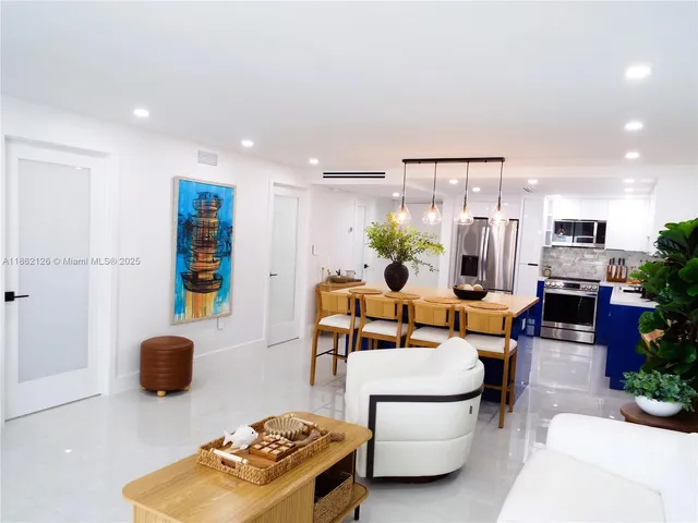 a dining room with furniture and potted plants