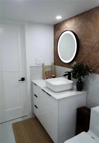 a bedroom with a bed and a night stand