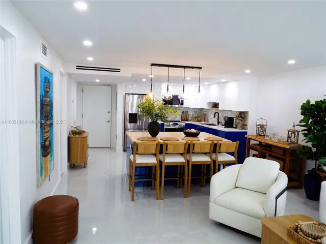 a kitchen with stainless steel appliances a stove a sink a microwave a refrigerator and cabinets