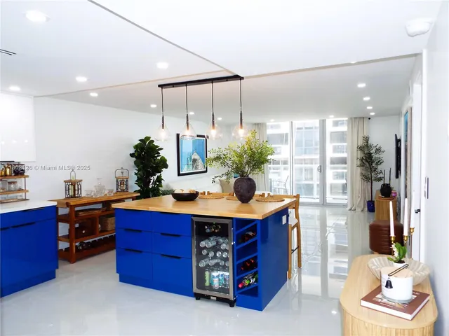 a living room with furniture a couch and potted plants