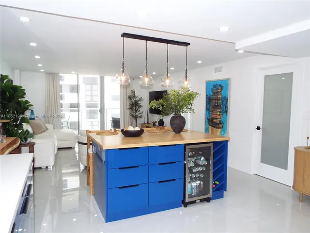 a living room with furniture a chandelier and a dining table