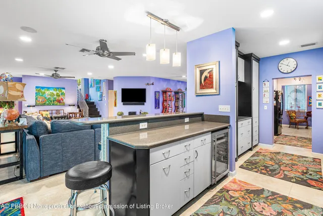 a kitchen with stainless steel appliances kitchen island granite countertop a sink and cabinets