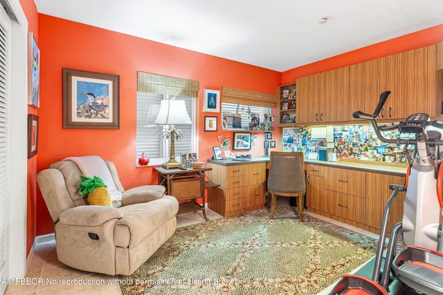 a living room with furniture a window and a flat screen tv