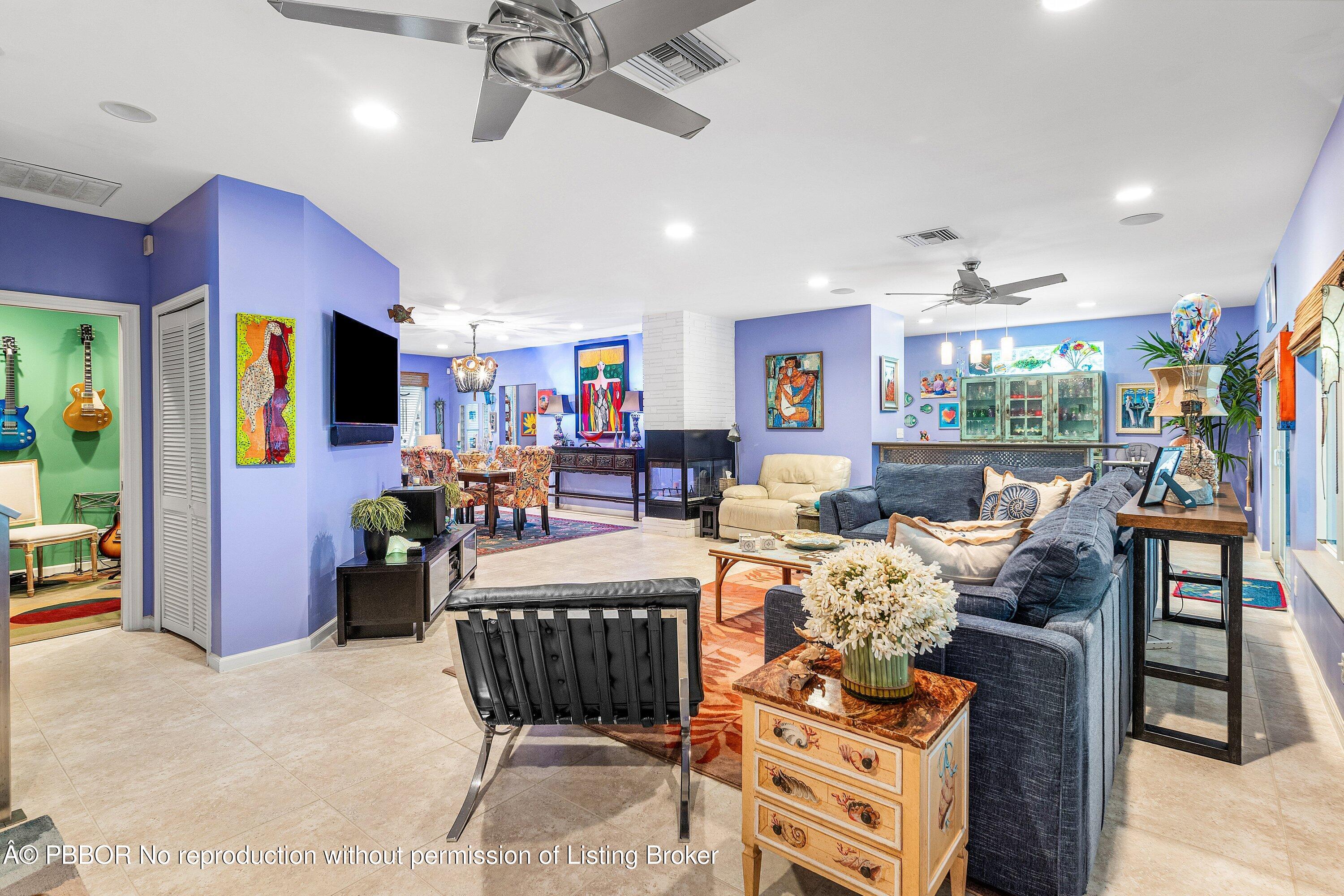 110 Dolphin Road Ocean Ridge, FL 33435 - Photo 8 of 33 a living room with furniture a flat screen tv and a large window
