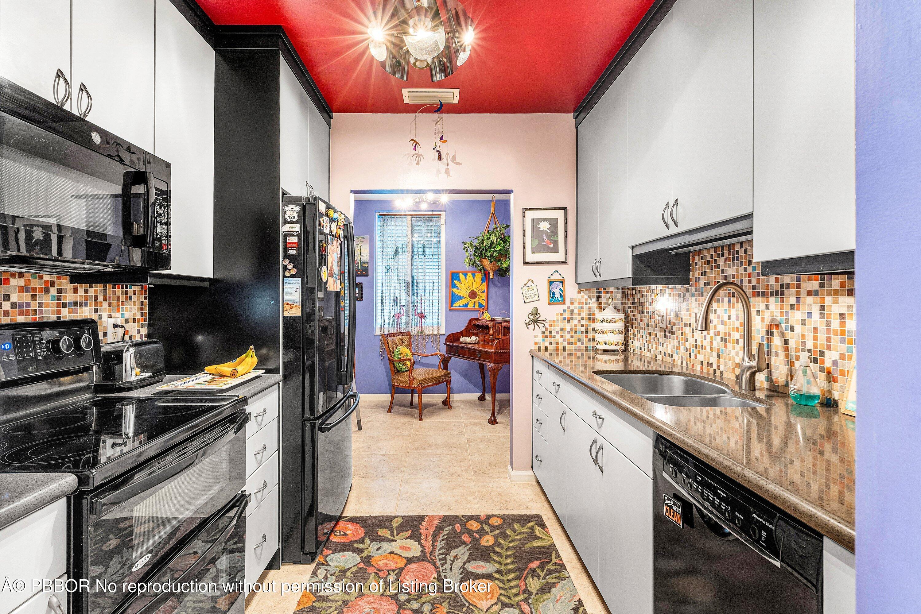 110 Dolphin Road Ocean Ridge, FL 33435 - Photo 10 of 33 a kitchen with a sink stove and cabinets