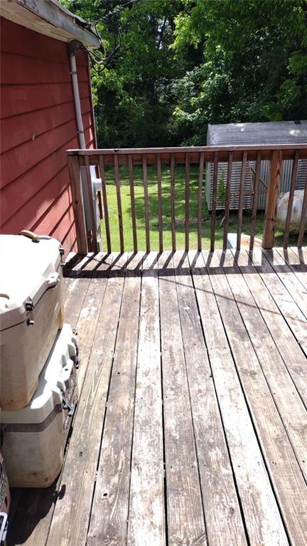136 Hill Street Commerce, GA 30529 - Photo 2 of 27 a view of balcony with wooden floor and fence