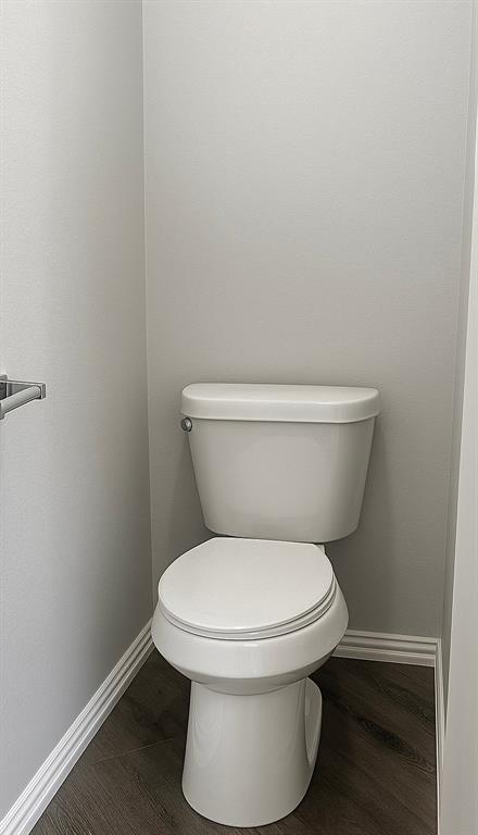 5729 Christy Lane Haltom City, TX 76137 - Photo 12 of 24 Bathroom with baseboards and dark wood finished floors