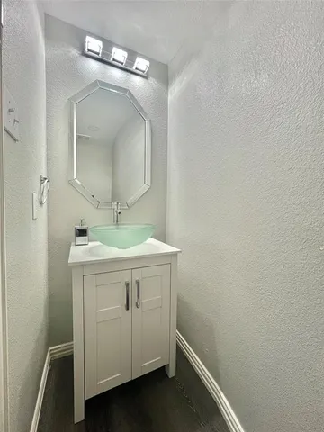 a bathroom with a sink vanity and a mirror