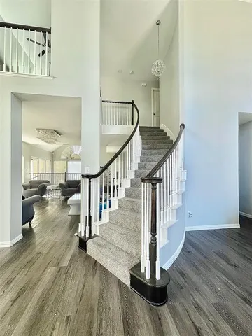 a view of entryway and hall with wooden floor