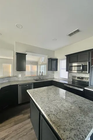 a kitchen with a stove and a sink