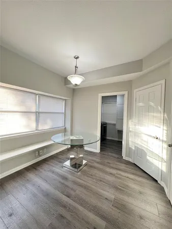 a view of a room with wooden floor and window