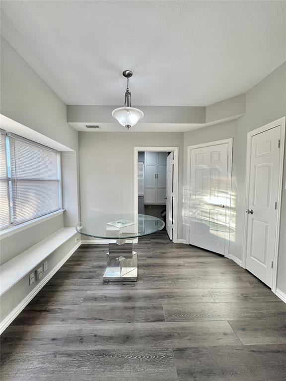 5729 Christy Lane Haltom City, TX 76137 - Photo 9 of 24 Unfurnished dining area with wood finished floors and baseboards