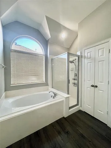 a bathroom with a bathtub and a shower