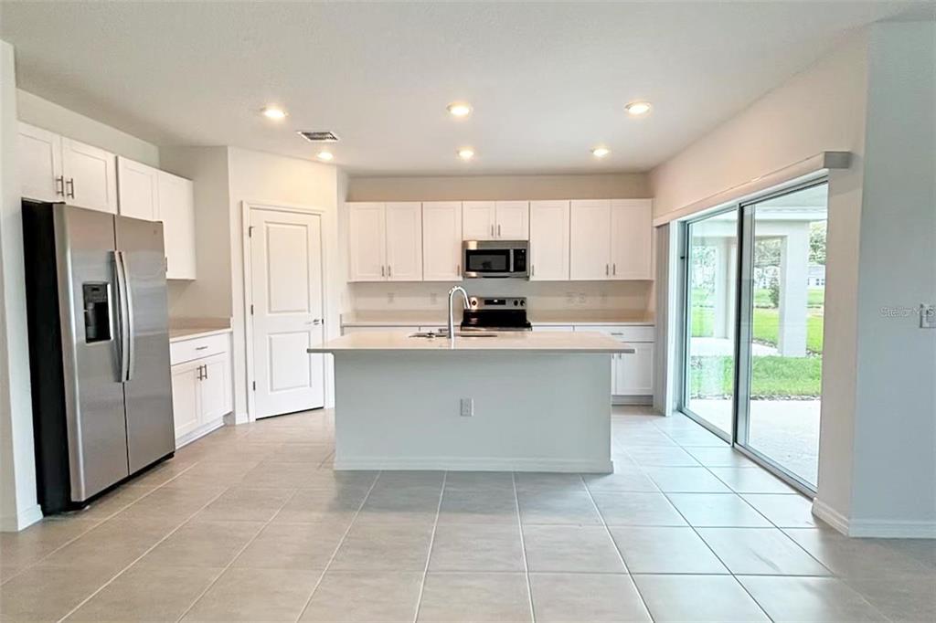 186 Jones Fish Camp Road Edgewater, FL 32141 - Photo 2 of 15 a kitchen with stainless steel appliances granite countertop a stove a refrigerator a sink and a microwave