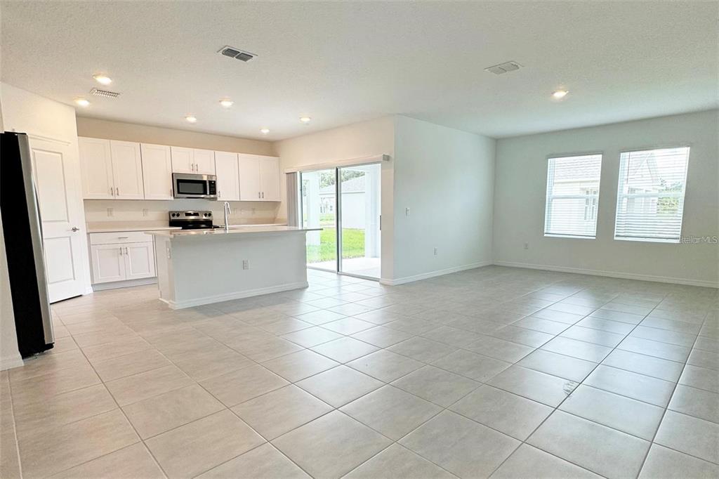 186 Jones Fish Camp Road Edgewater, FL 32141 - Photo 3 of 15 a kitchen with stainless steel appliances a refrigerator sink and cabinets