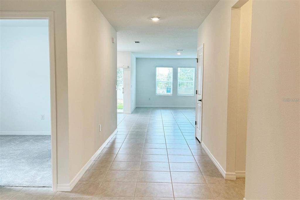 186 Jones Fish Camp Road Edgewater, FL 32141 - Photo 4 of 15 a view of a hallway with wooden floor and a window