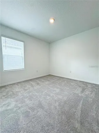 an empty room with a empty space and a window
