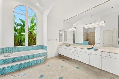 a large white tub sitting in a bathroom