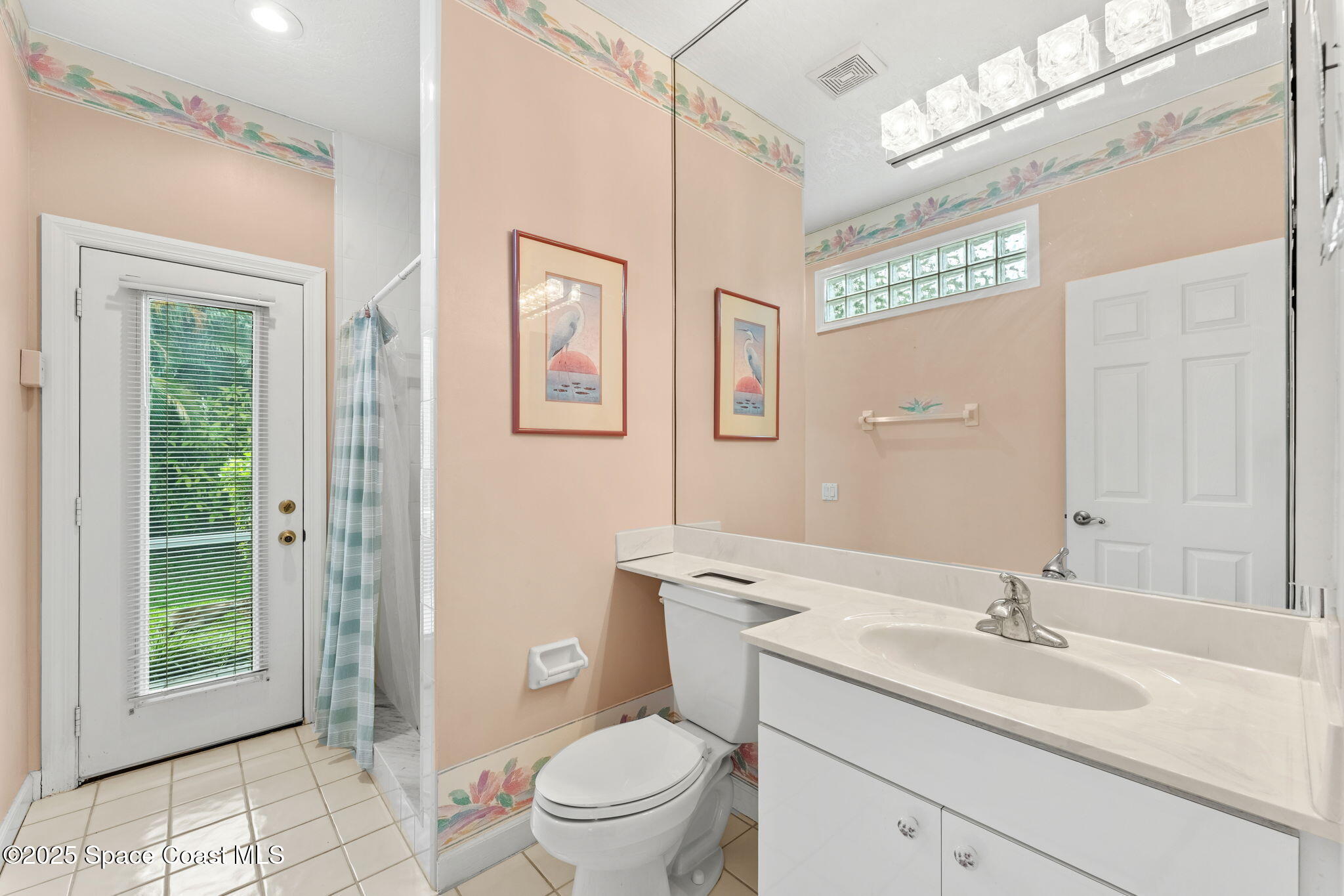 248 Loggerhead Drive Melbourne Beach, FL 32951 - Photo 19 of 35 a bathroom with a toilet a sink and a large mirror