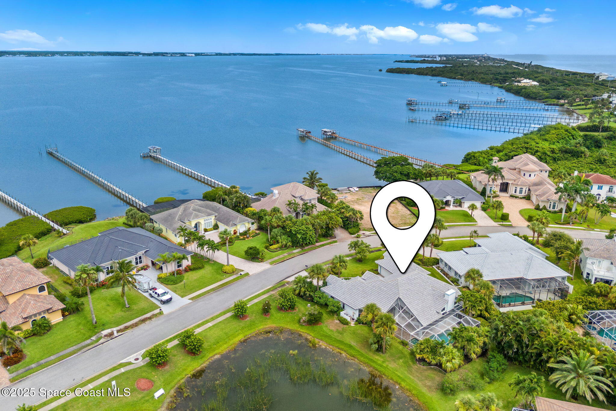 248 Loggerhead Drive Melbourne Beach, FL 32951 - Photo 2 of 35 an aerial view of a house with a yard and lake view
