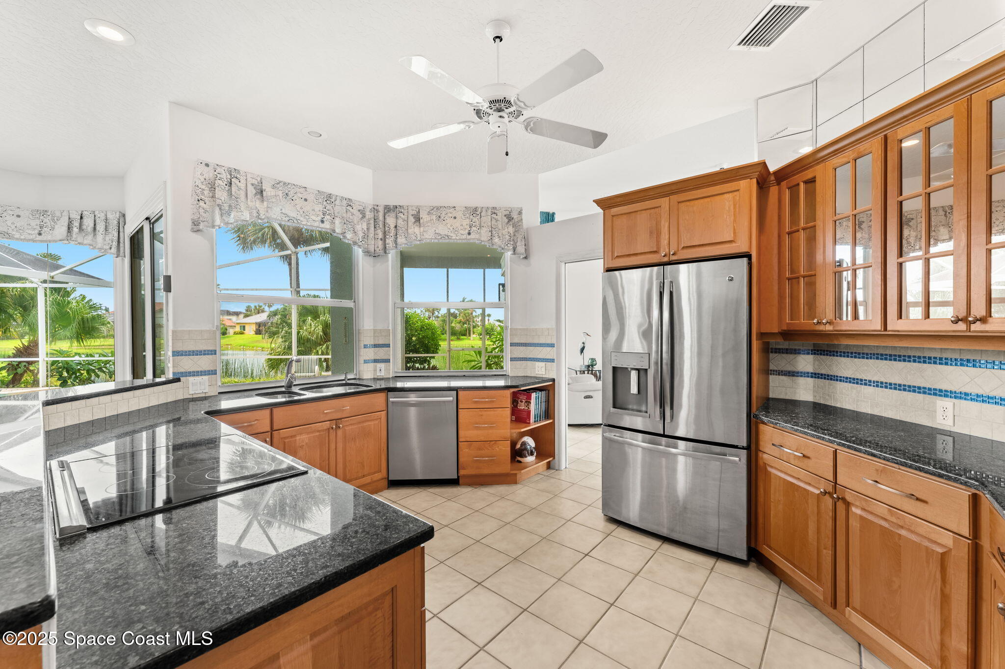 248 Loggerhead Drive Melbourne Beach, FL 32951 - Photo 8 of 35 a kitchen with stainless steel appliances granite countertop a refrigerator a sink and dishwasher