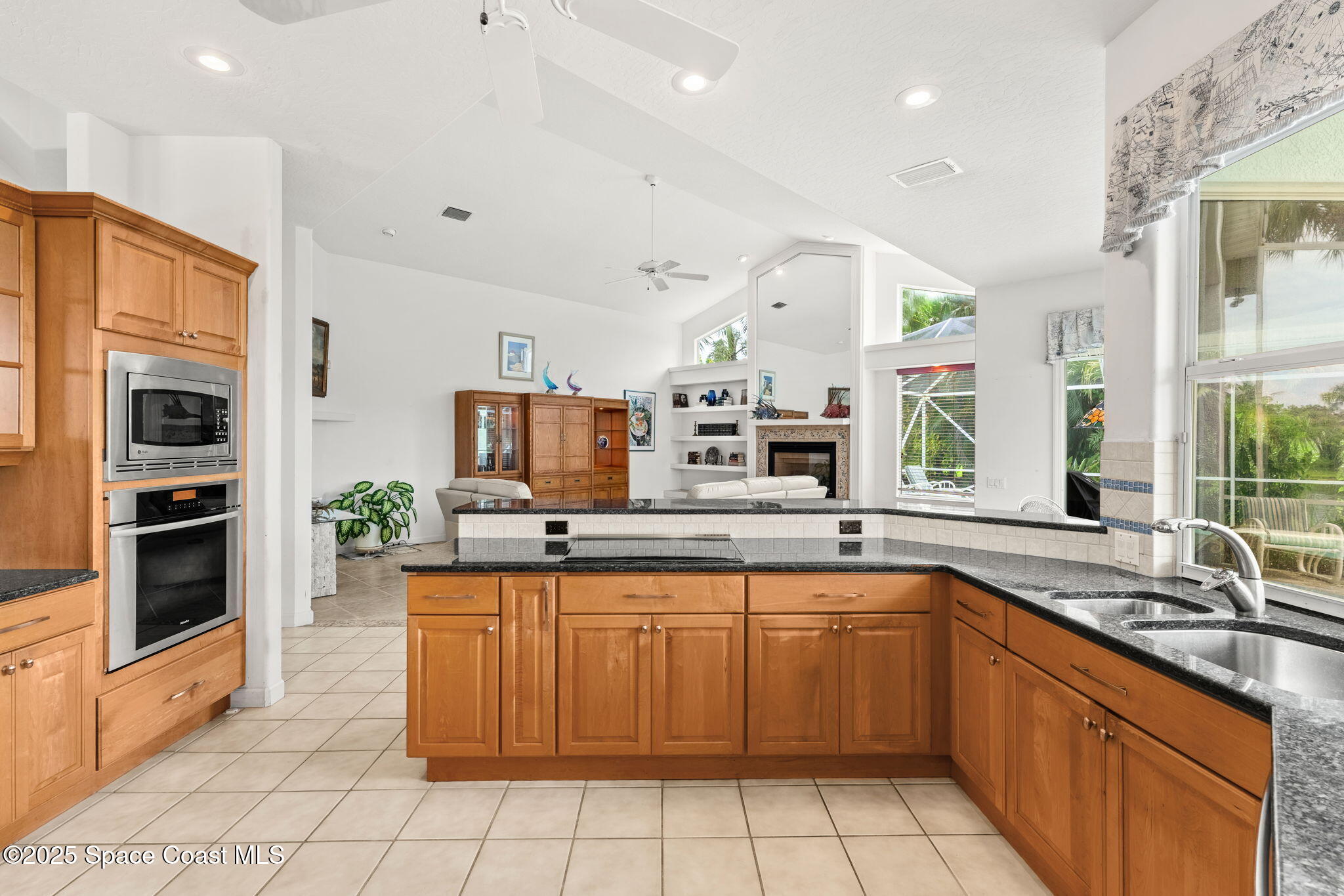 248 Loggerhead Drive Melbourne Beach, FL 32951 - Photo 9 of 35 a kitchen with a sink counter top space stainless steel appliances and a large window
