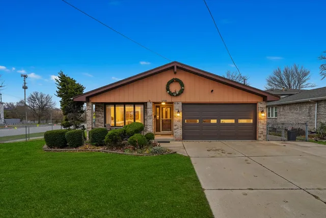a front view of a house with a garden and yard