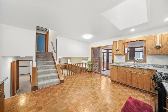 a view of a kitchen with furniture and staircase