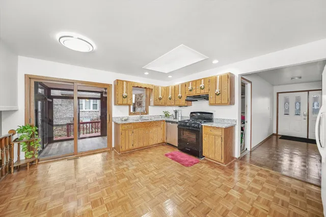 a large kitchen with stainless steel appliances granite countertop a large counter top and a stove