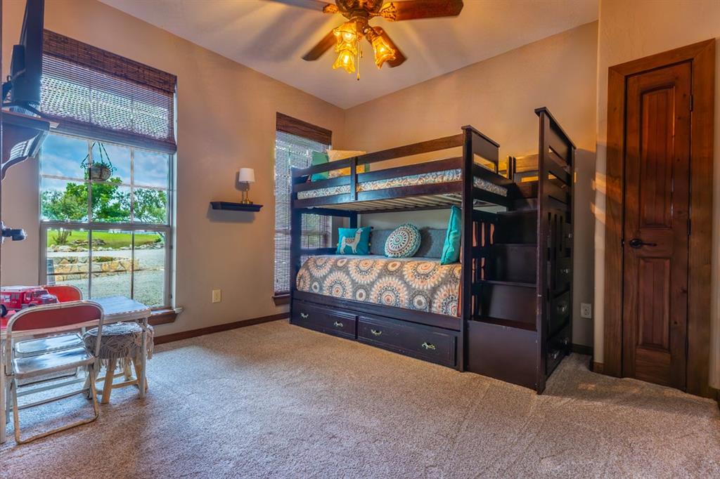 7060 Hells Gate Loop Strawn, TX 76475 - Photo 11 of 40 a bedroom with furniture and a window