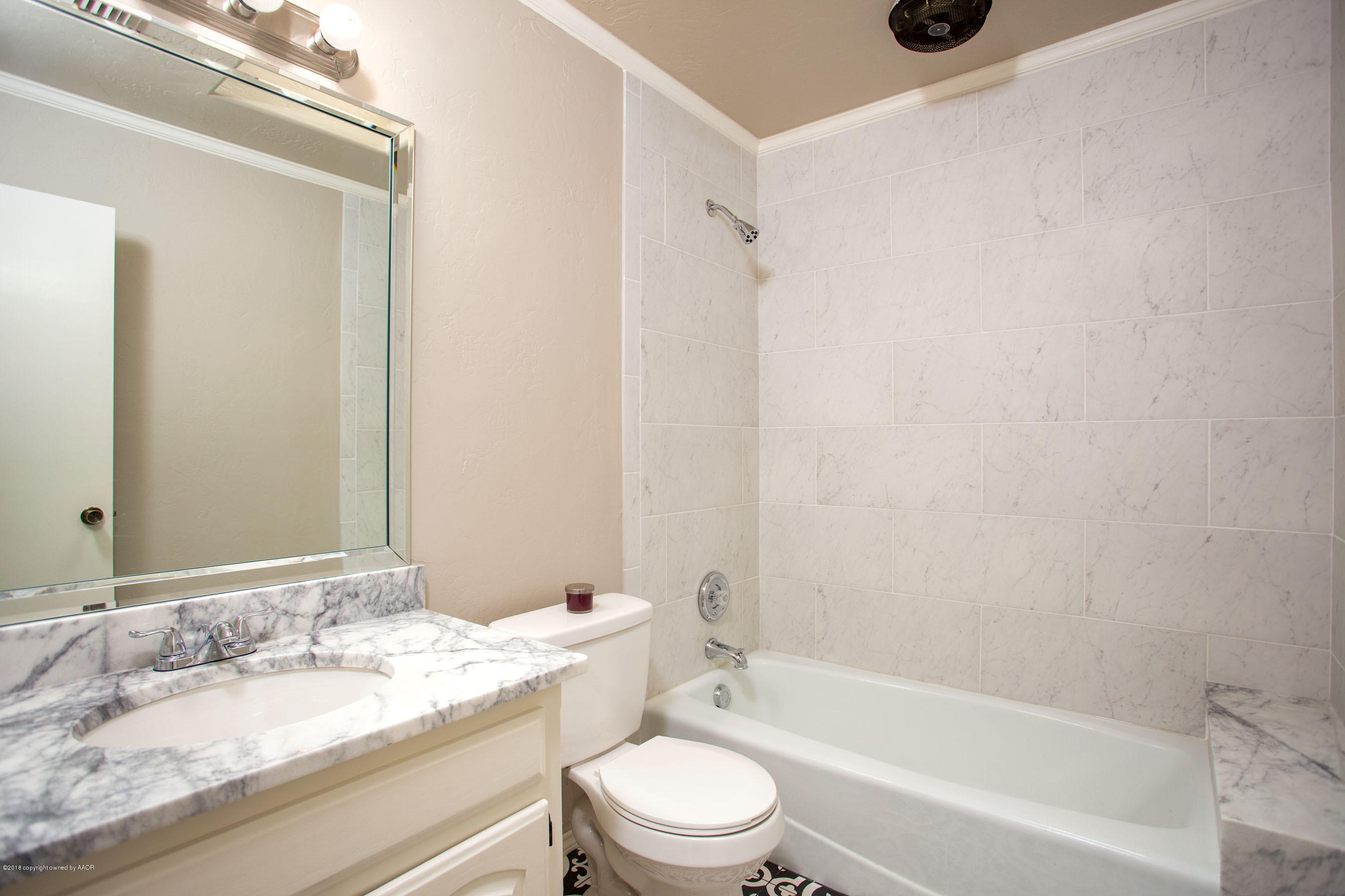 8209 Wrangler Trail Amarillo, TX 79110 - Photo 12 of 22 a bathroom with a granite countertop sink toilet a mirror and shower
