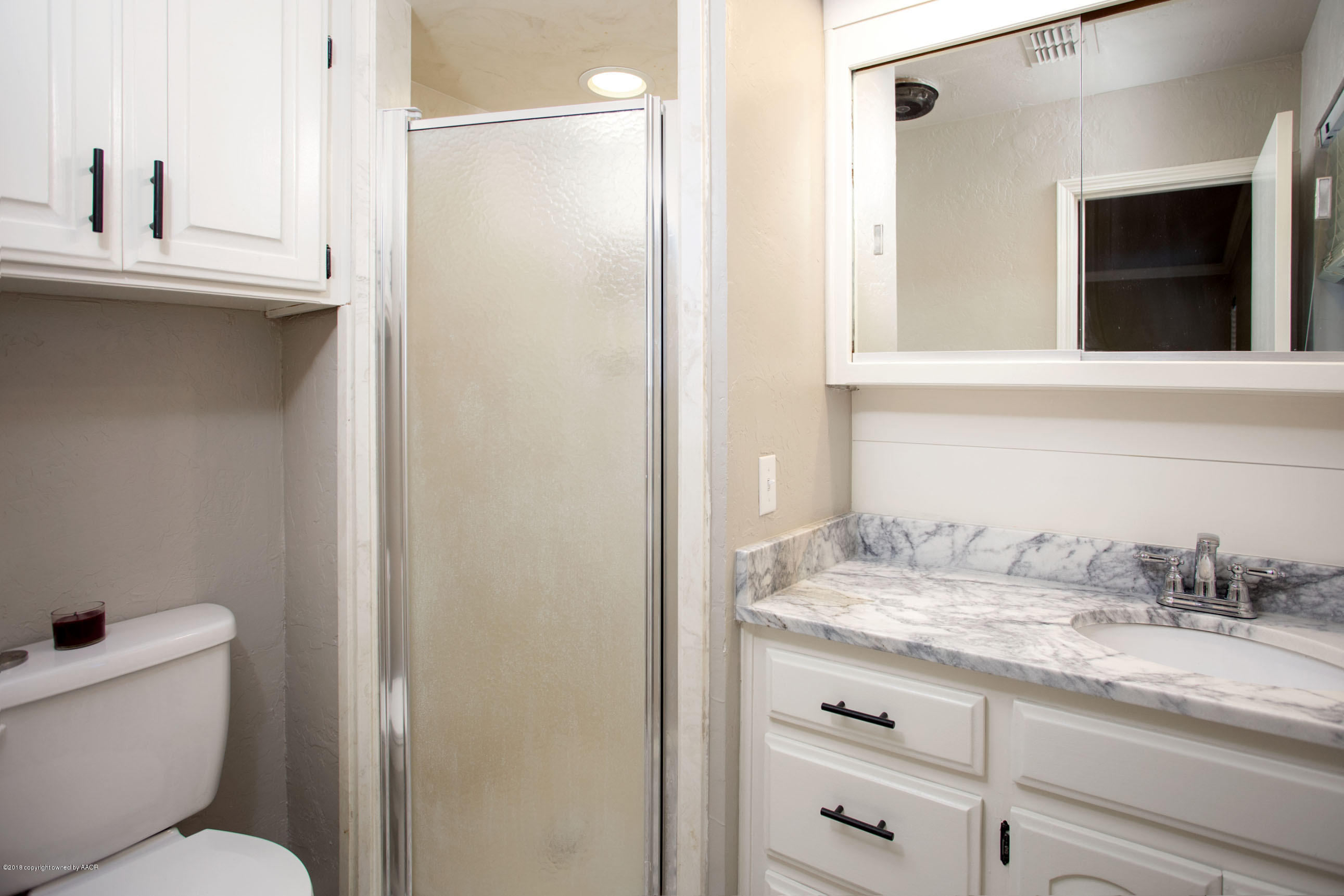 8209 Wrangler Trail Amarillo, TX 79110 - Photo 15 of 22 a bathroom with a granite countertop sink toilet and shower