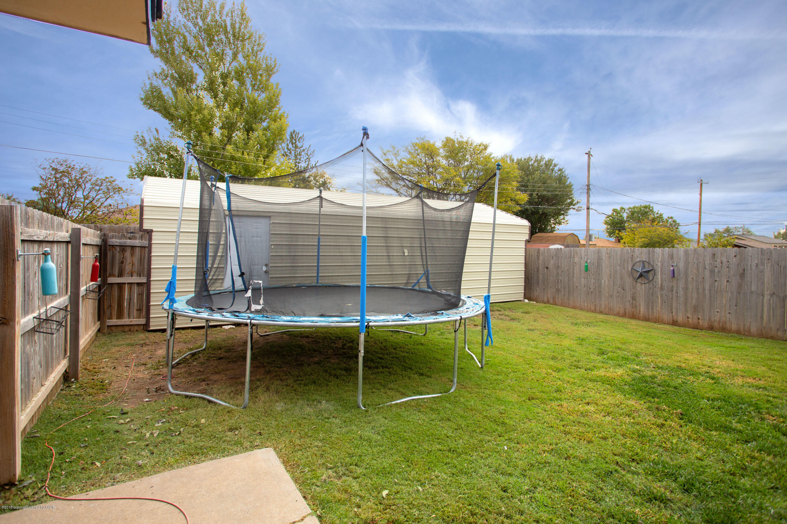 8209 Wrangler Trail Amarillo, TX 79110 - Photo 18 of 22 a view of a chairs and table in the backyard