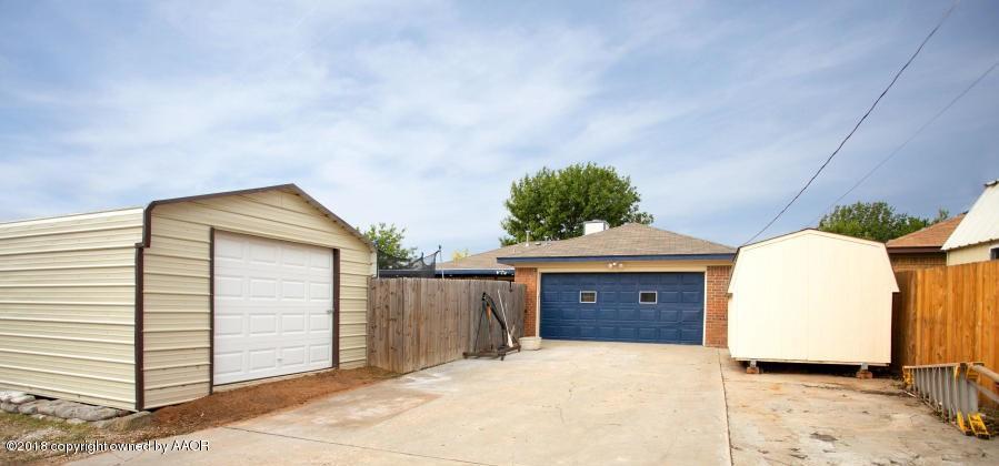8209 Wrangler Trail Amarillo, TX 79110 - Photo 20 of 22 a front view of a house with a yard and garage
