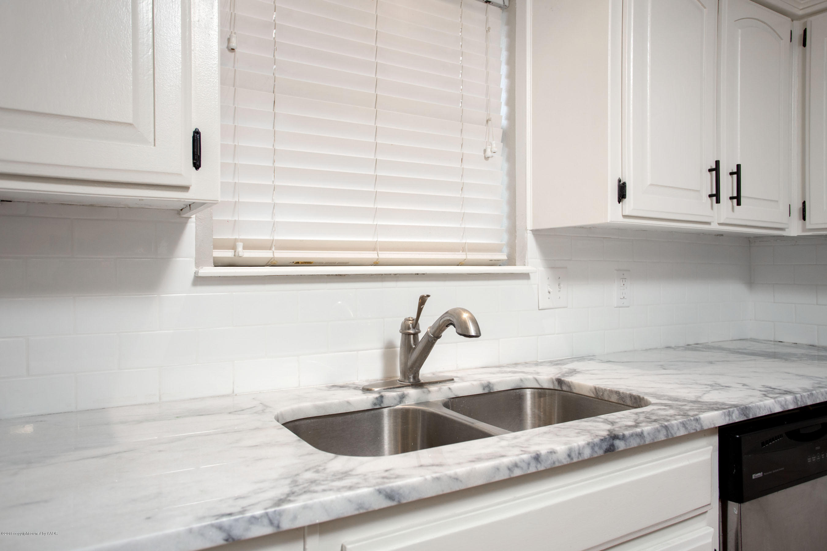8209 Wrangler Trail Amarillo, TX 79110 - Photo 6 of 22 a kitchen with granite countertop a sink and a window