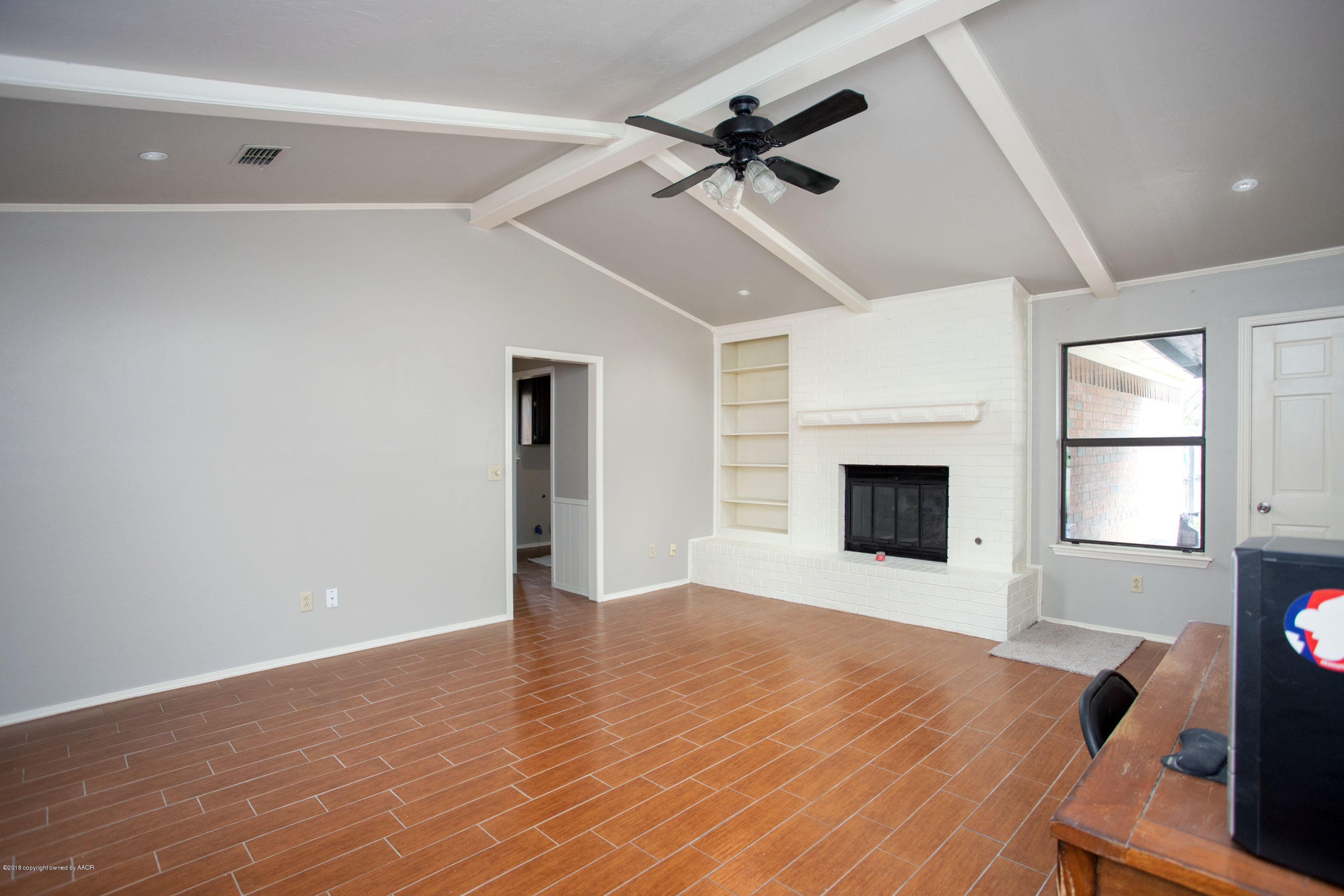 8209 Wrangler Trail Amarillo, TX 79110 - Photo 7 of 22 a view of an empty room with a fireplace and a window