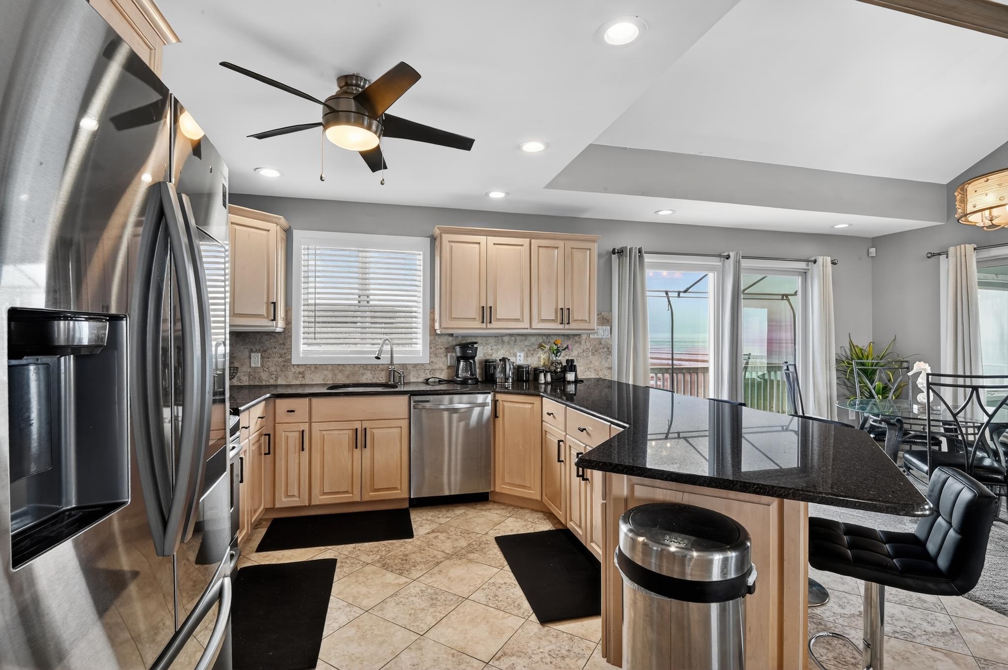 6 Pierces Point Road Cape May Court House, NJ 08210 - Photo 7 of 30 a kitchen with granite countertop kitchen island stainless steel appliances a table and a refrigerator