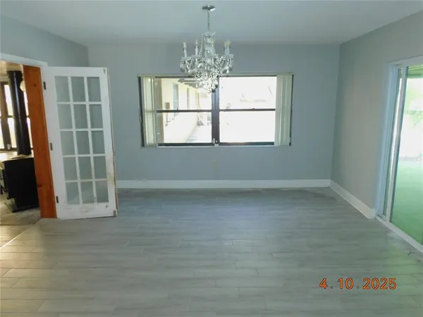 an empty room with windows and entrance