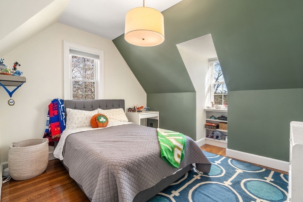 170 Benvenue Street Wellesley, MA 02482 - Photo 12 of 22 a bedroom with a bed and a chandelier