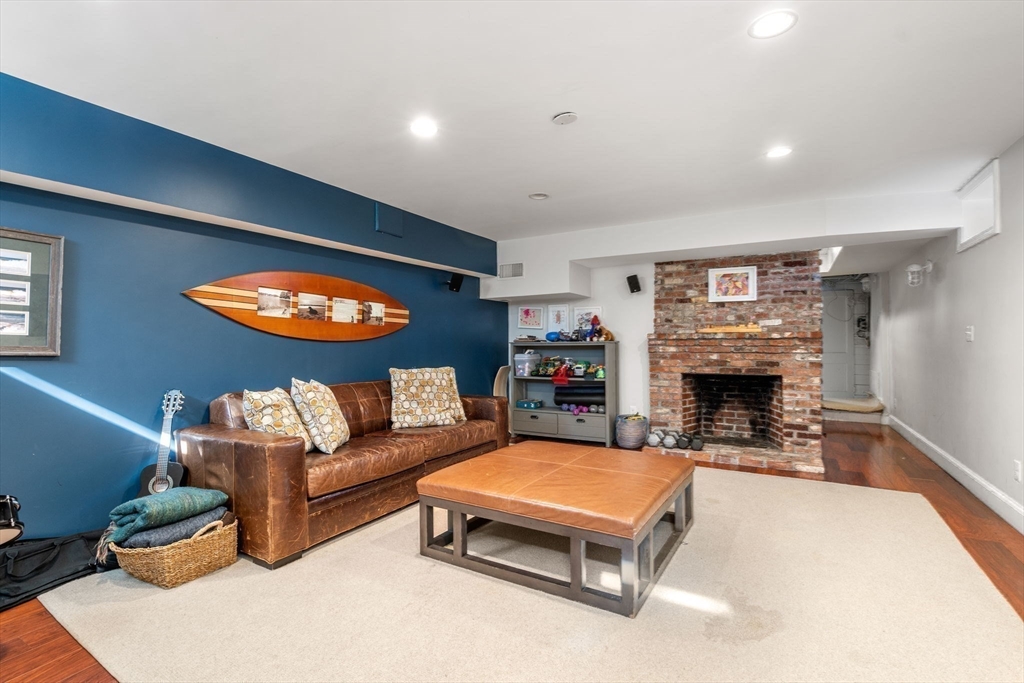 170 Benvenue Street Wellesley, MA 02482 - Photo 18 of 22 a living room with furniture a fireplace and a table