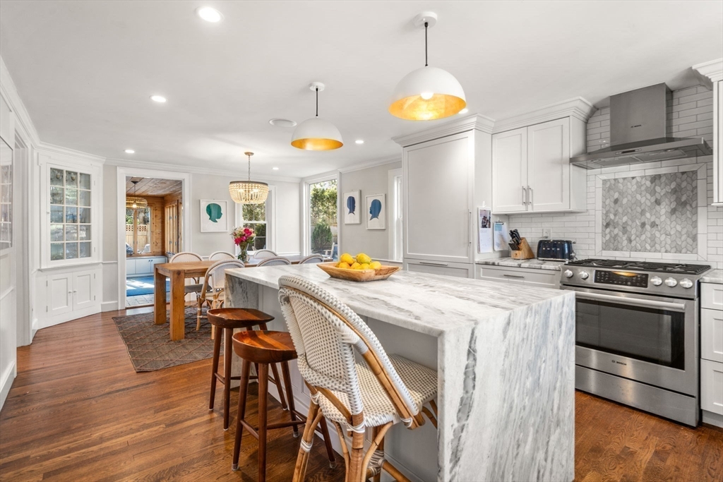170 Benvenue Street Wellesley, MA 02482 - Photo 3 of 22 a kitchen with stainless steel appliances granite countertop a stove a sink a dining table and chairs with wooden floor